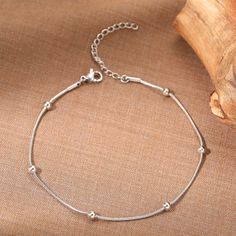 Adorn your ankle with the elegance and sophistication of our Stainless Steel Snake Bead Chain Anklet. Perfect for modern women who cherish a blend of contemporary style and a hint of punk flair, this anklet makes a statement at any occasion, be it a party, wedding, or engagement. Product Features This exquisite anklet is crafted from high-quality stainless steel, ensuring durability and resistance against tarnishing. The geometric bead design adds a trendy touch, making it a must-have accessory for the fashion-forward. Its adjustable length of 22cm with an extra 5cm extender ensures a comfortable fit for all. Benefits Durable and tarnish-resistant construction. Adjustable length for a custom fit. Stylish bead design that complements any outfit. Lightweight and comfortable, perfect for exte Anklet Designs Silver, Silver Chain Anklet, Silver Anklets Designs, Anklet Silver, Anklet Designs, Silver Anklet, Ankle Jewelry, Women Anklets, Ankle Chain