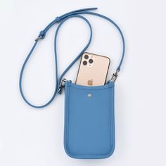 The crossbody phone bag is crafted from genuine cowhide top grain leather (togo), setting a high standard for style and durability. Perfect for those who appreciate the elegance of simplicity, this bag boasts an easy-access design with 3 card slots at the back. The open interior, secured by a top button closure, provides a safe and convenient space for your essentials. The strap, made from the same superior leather, is adjustable to suit your comfort and style.The bag is available in five captiv Pink Crossbody Wallet With Phone Bag, Pink Rectangular Leather Phone Bag, Blue Phone Bag With Adjustable Strap, Pink Phone Bag With Adjustable Strap For On-the-go, Pink Shoulder Bag With Mobile Phone Pocket For On-the-go, Crossbody Phone Bag, Togo Leather, Mini Crossbody Bag, Mini Crossbody