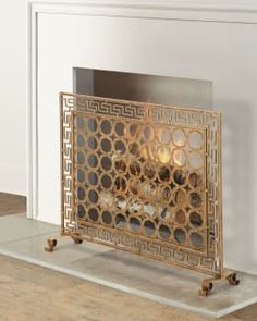 a fireplace screen sitting on top of a hard wood floor