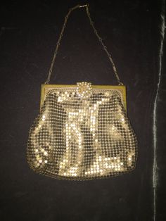 "Small and attractive gold metal mesh authentic 1920's Whiting & Davis evening bag with rhinestone clasp and sold brass frame. The jewelry style chain makes this bag unique. Rhinestone clasp is missing a few stones (see link below for rhinestone replacement) Beautiful peach satin lining is in good condition. Wonderful dancing bag to hold theater tickets, lipstick and compact mirror. Whiting & Davis has been joining little metal tiles into shimmering sheets of possibility since 1876. Fash Vintage Gold Bag With Chain Strap, Vintage Gold Bags With Chain Strap, Vintage Party Jewelry With Chain Strap, Gold Metal Evening Bag, Gold Metal Evening Bag For Formal Occasions, Gold Evening Jewelry With Clasp, Gold Jewelry With Clasp For Evening, Antique Gold Bag For Vintage Events, Gold Antique Bag For Vintage Events