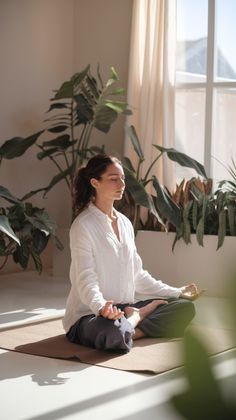 a woman is sitting on the floor doing yoga