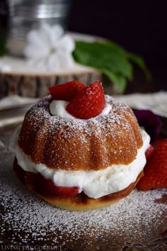 a pastry with strawberries on top and powdered sugar around the edges is sitting on a plate