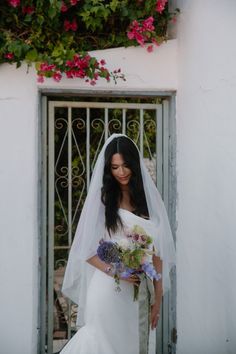 a woman in a wedding dress holding a bouquet