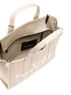 Beige cotton medium The Tote bag from Marc Jacobs featuring logo print to the front, logo patch to the rear, two rounded top handles, adjustable detachable shoulder strap and top zip fastening. | Marc Jacobs medium The Tote bag Bags For University For Women, Bags For University, Beige Tote Bag, Beige Tote, Medium Tote Bag, Marc Jacobs Tote, Bold Logo, Small Tote Bag, Marc Jacobs Bag