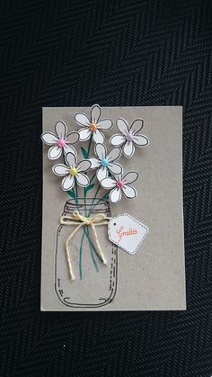 a card with some flowers in a mason jar on it's side and a tag that says goodbye