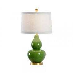 a green lamp with a white shade on it