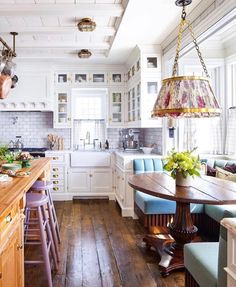 an image of a kitchen with white cabinets and wood flooring on the bottom right hand corner