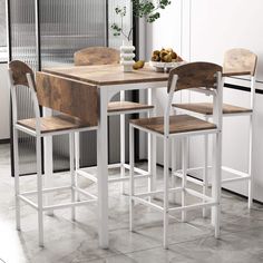 a kitchen table with three chairs and a vase on the counter top next to it