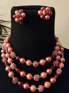 "Vintage 1950s pink 3-strand necklace and earring set with faux pearls and sugar beads. Made in Japan. Sugar band on one earring has worn off a bit. Adjustable necklace 15-17.5\"." Vintage Pink Beaded Necklace With Round Beads, Pink Multi-strand Jewelry For Party, Pink Vintage Beaded Necklaces With Colorful Beads, Pink Costume Jewelry Beaded Necklaces For Party, Pink Pearl Beaded Necklaces For Parties, Vintage Pink Beaded Jewelry, Pink Vintage Beaded Jewelry, Vintage Pink Beaded Necklaces For Jewelry Making, Vintage Pink Pearl Necklaces