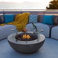 a fire pit sitting on top of a blue couch