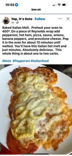 a white plate topped with lasagna covered in sauce and cheese on top of it