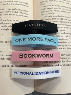 three bookmarks are placed on top of an open book