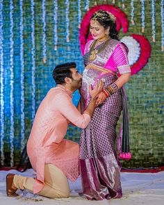 a man kneeling down next to a woman