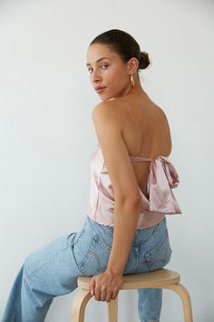 Channel your inner it-girl in the Hallie Strapless Open Back Satin Top! This crop top features a tie back closure, cowl open back, and strapless satin fit! Available in Rose Gold and Champagne; Pair this shimmery top with some jeans to polish off the perfect going out outfit!Details: Self: 97% Polyester, 3% Spandex Lining: 100% Polyester Some Stretch Tie Back Closure Partially Lined Hand Wash Cold/ Line Dry Strapless Tube Top With Tie Back, Party Satin Crop Top With Built-in Bra, Glamorous Satin Crop Top For Night Out, Backless Pink Crop Top For Night Out, Pink Backless Crop Top For Night Out, Summer Satin Halter Neck Crop Top, Satin Crop Top With Built-in Bra For Night Out, Satin Backless Party Top, Chic Satin Backless Top