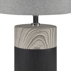 a black and white table lamp with a grey shade on it's side,