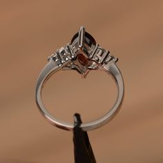 It is a natural garnet ring. The main stone is 7mm*12mm marquise cut, weight about 2.25 carats. The basic metal is sterling silver and plated with rhodium. To change the metal to a solid gold (white/rose) or platinum is also available, please ask for a quotation if you want. You can also go to my shop Home for more elegant rings: https://www.etsy.com/shop/godjewelry?ref=hdr_shop_menu More garnet rings: https://www.etsy.com/shop/godjewelry?section_id=20709242 Customization is always welcome and p Silver Marquise Cut Ruby Promise Ring, Silver Marquise Ruby Ring For Anniversary, Marquise Garnet Ring For Anniversary, Silver Marquise Cut Birthstone Ring For Anniversary, Elegant Rings, January Birthstone Rings, Red Garnet Ring, Silver Engagement Ring, Sterling Silver Engagement Rings