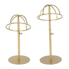 two gold metal stands with circular bases