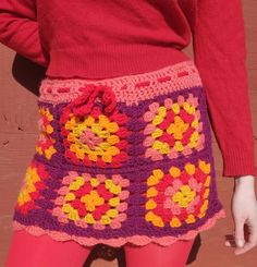 a close up of a woman's skirt with crocheted flowers on it