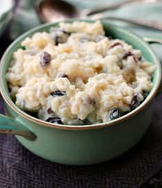 a green bowl filled with oatmeal and raisins