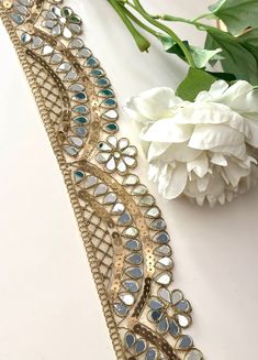 7cm Pale Gold Scallop Mirror Trim - Elegant Cutwork Sequin Saree Border Elevate your projects with our 7cm Pale Gold Scallop Mirror Trim! This exquisite trim features intricate scalloped cutwork and sequin embellishments, perfect for adding a touch of sophistication to sarees, cinturon espajo (mirror belts), neckbands, and more. Materials: High-quality handmade lace Reflective pale gold mirrors and shimmering sequins Durable and lightweight Features: Beautiful scalloped design for an elegant loo Bohemian Gold Dupatta For Celebration, Gold Bohemian Dupatta With Mirror Work, Bohemian Gold Dupatta With Mirror Work, Scallop Mirror, Indian Mirror, Scalloped Mirror, Mirror Work Blouse Design, Geometric Mirror, Mirror Work Blouse