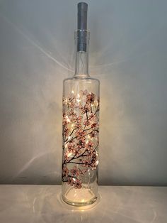 a bottle with lights in it sitting on a table