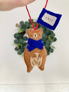 a teddy bear ornament hanging from a string