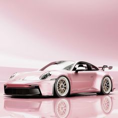 a pink sports car parked in front of a mirror