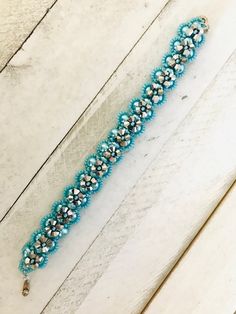 "This bracelet is a beauty and would be the perfect gift for Mother's Day or any other special occassion.  It's loaded with blue 6mm rounds beads, 4mm silver bicones and shiny blue seed beads.  It has a snap type closure.  Although it is 8\" long, it will only fit up to a 7\" wrist unless extra links are added.   This is my adaptation of designer Deborah Farrand's design called X's and O's Bracelet." Blue Beaded Bracelets With Spacer Beads For Party, Blue Beaded Bracelets With 8mm Beads For Party, Blue Beaded Bracelets For Party, Turquoise Bracelets With Faceted Beads For Party, Turquoise Beaded Crystal Bracelet For Party, Blue Bracelets With 8mm Beads For Party, Party Bracelets With Turquoise Faceted Beads, Party Bracelet With Turquoise Faceted Beads, Adjustable Turquoise Crystal Bracelet With Silver Beads