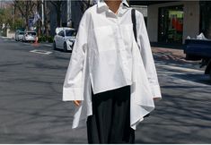 Get the perfect street/urban look with this women's white asymmetrical hem loose-fit button-up t-shirt. crafted with premium polyester and cotton fabric, it is comfortable and stylish. shop now! Loose White Blouse, White Parties, 50's Fashion, Korean Fashion Summer, Design Blouse, Lace Shirt, Asymmetrical Hem, Batwing Sleeve, White Blouse