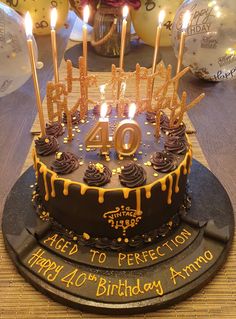 a birthday cake with candles on it and the number forty eight in gold icing