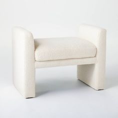 a white chair sitting on top of a white floor