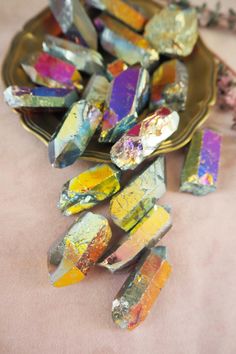 some colorful rocks are on a gold plate