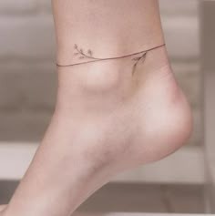 a woman's bare foot with a small tattoo on the side of her leg