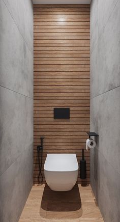 a white bath tub sitting inside of a bathroom next to a toilet paper dispenser