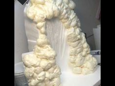 there is a white sculpture made out of cotton on the table and it looks like an arch