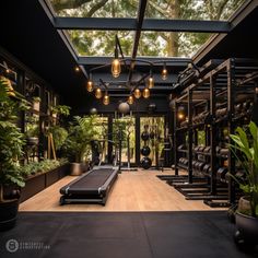 an indoor gym with lots of plants and exercise equipment