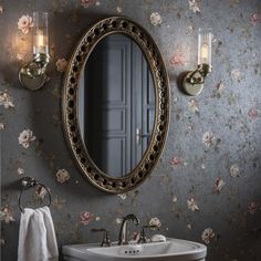 a bathroom sink sitting under a mirror next to a wall mounted faucet with flowers on it