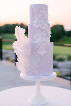 a white wedding cake with flowers on it