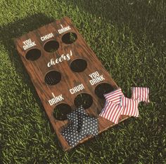 an american flag themed cornhole toss game on the grass with two bow ties laying next to it