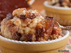 a close up of a bowl of food with raisins and nuts on top