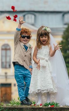 two young children dressed in wedding clothes and sunglasses