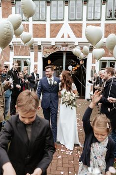 a bride and groom walk down the aisle as confetti is thrown around them