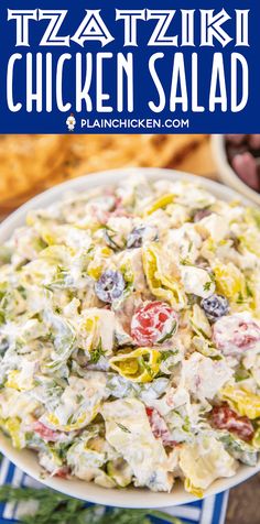 a bowl filled with chicken salad on top of a blue and white striped table cloth