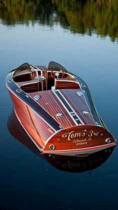 a small boat floating on top of a lake