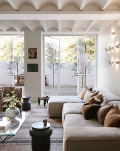 a living room filled with furniture and lots of windows