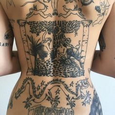 the back of a woman with tattoos on her body