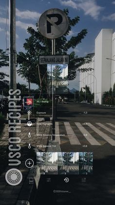 a street sign sitting on the side of a road next to a cross walk and trees