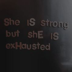 there is a sign that says she is strong but she is exhausted