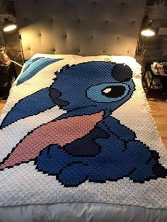 a crocheted blanket with stitching on it in the shape of an animal