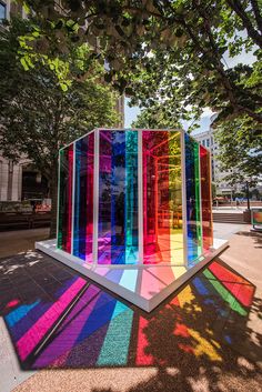 an art installation made out of multicolored glass in the middle of a park